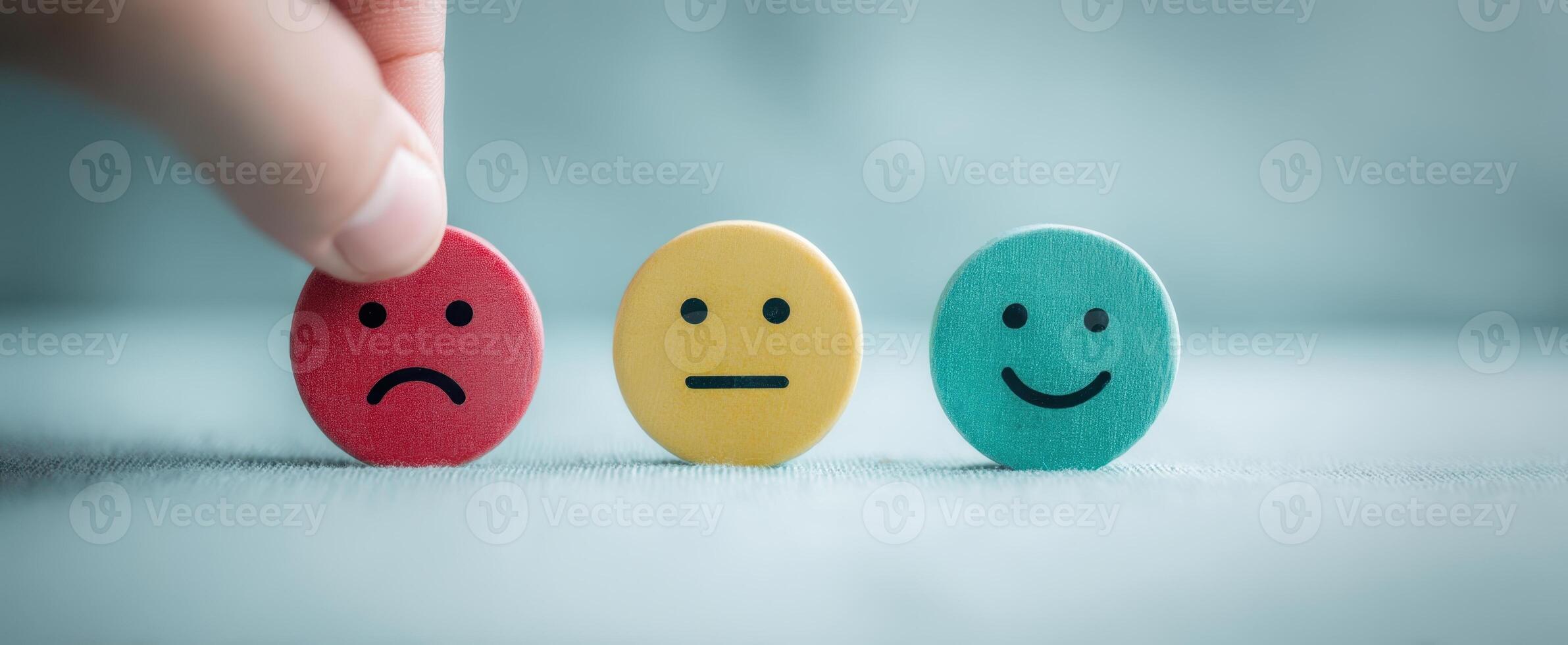 The hand selecting between emotional expression tokens for feedback. photo