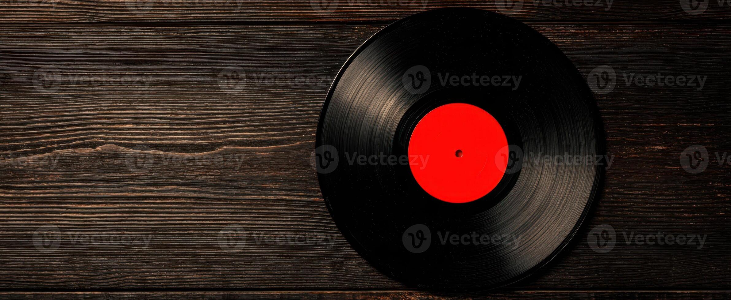 The vibrant vinyl record resting on a rustic wooden background photo