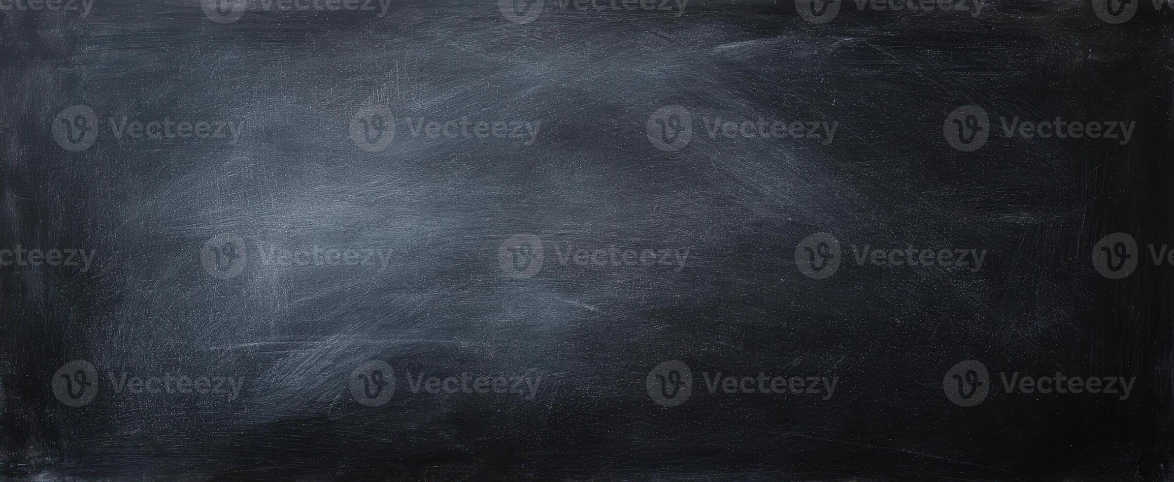 The textured black background featuring a smooth chalkboard surface for creative use. photo
