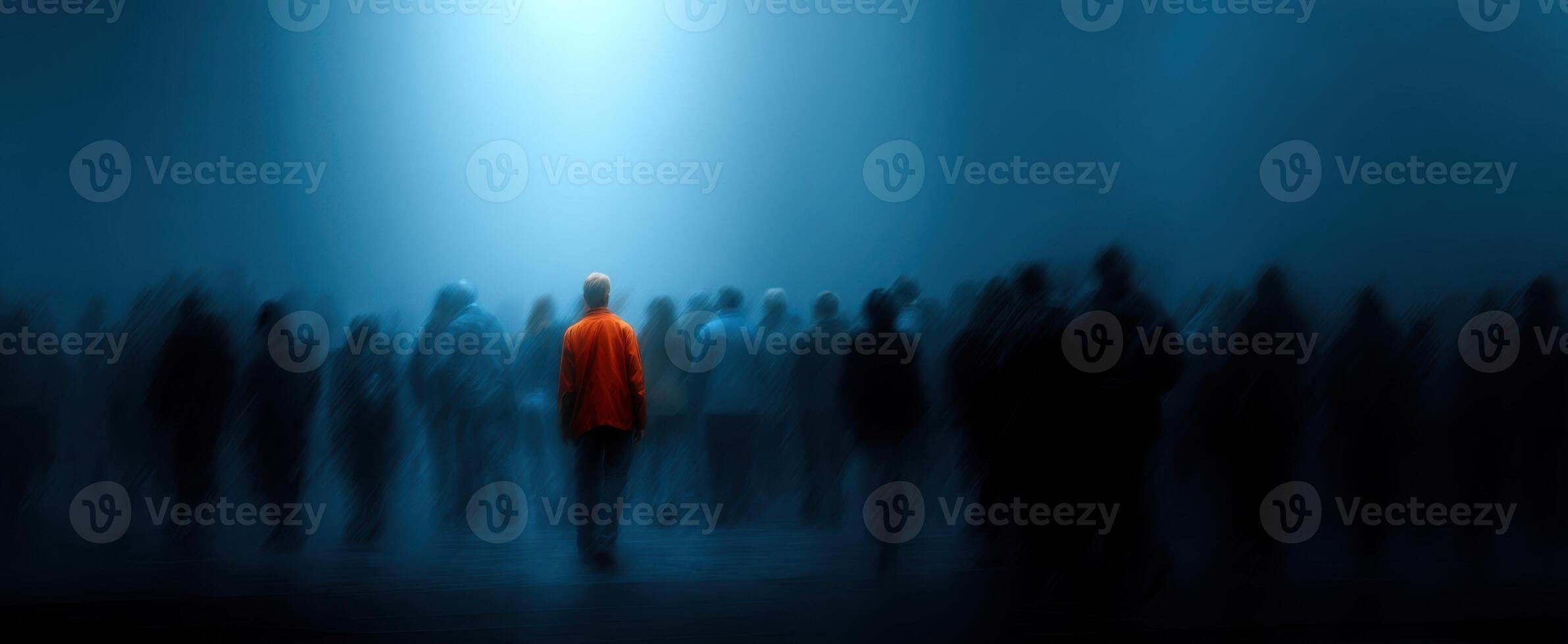 The solitary figure amidst a blurred crowd in an atmospheric setting. photo