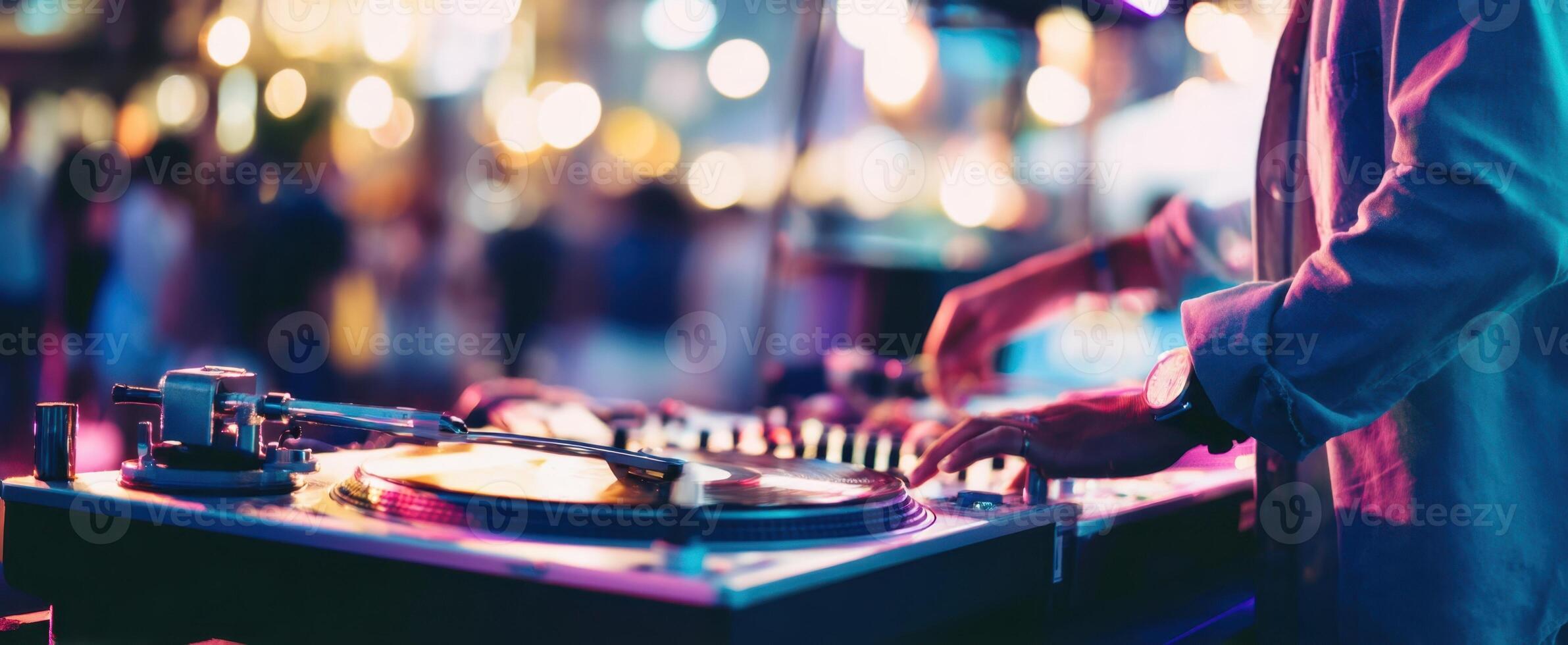 The DJ creating an electrifying atmosphere with vibrant tunes and lights. photo