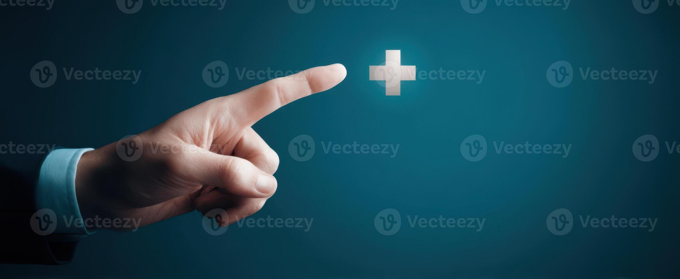 The hand reaching out to a glowing plus symbol on a blue background. photo