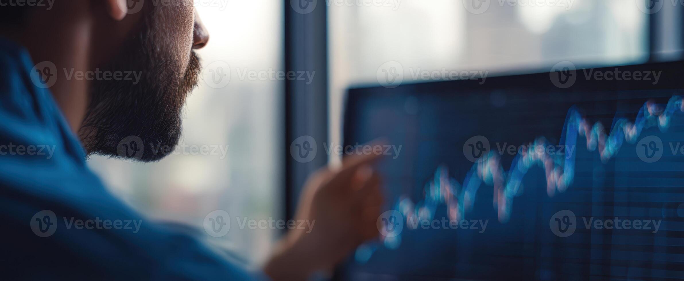 The man analyzing stock market trends and data on a computer screen. photo
