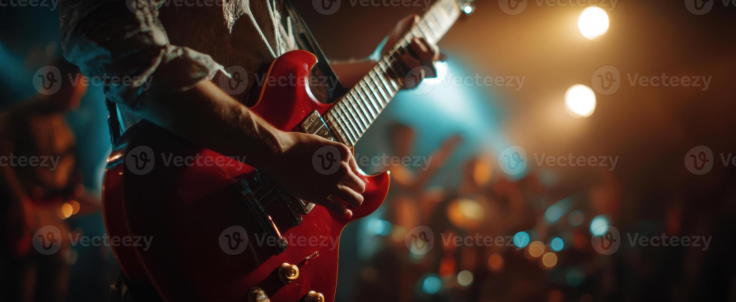 The electric guitar highlighted in a vibrant live music performance. photo