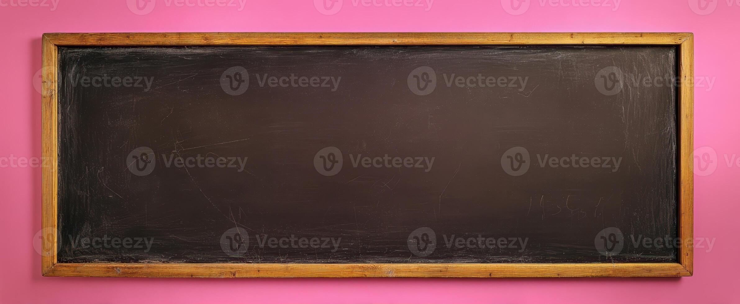 The empty chalkboard framed against a vibrant pink wall photo