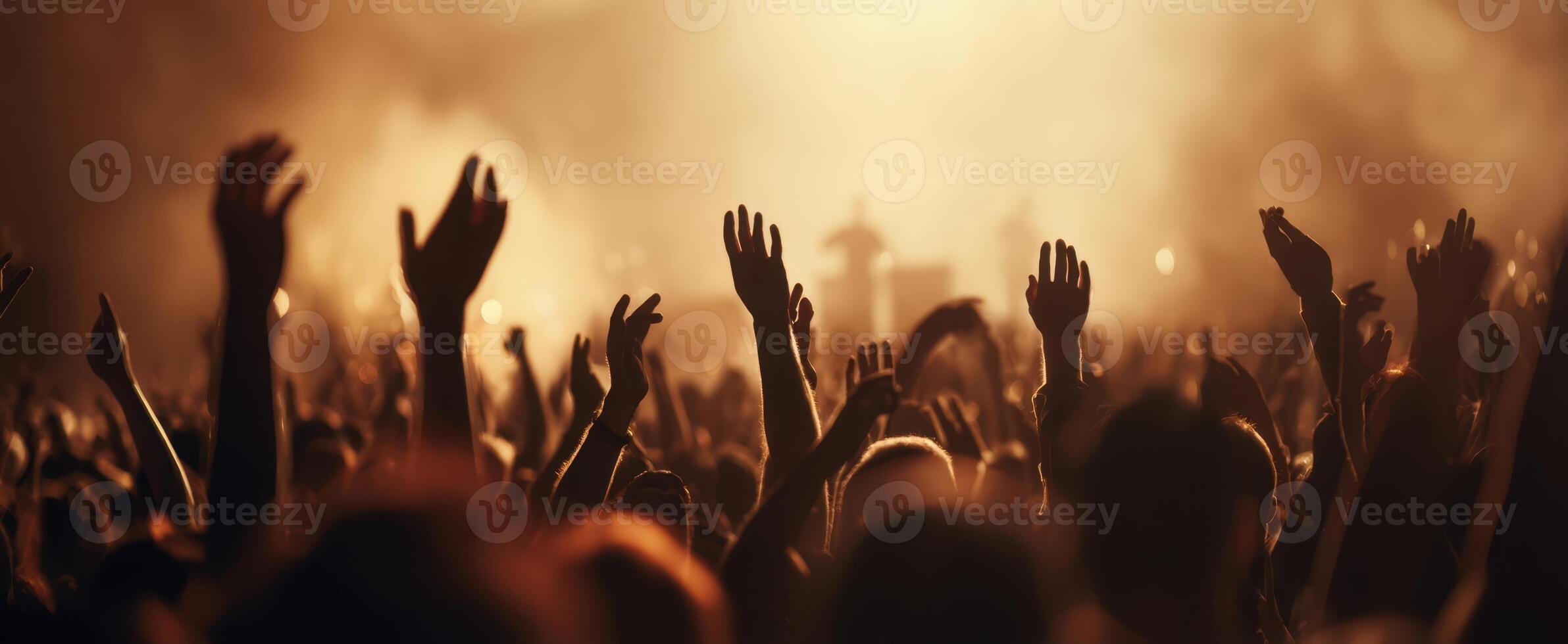 The crowd celebrating at a vibrant live music concert under dramatic lighting. photo