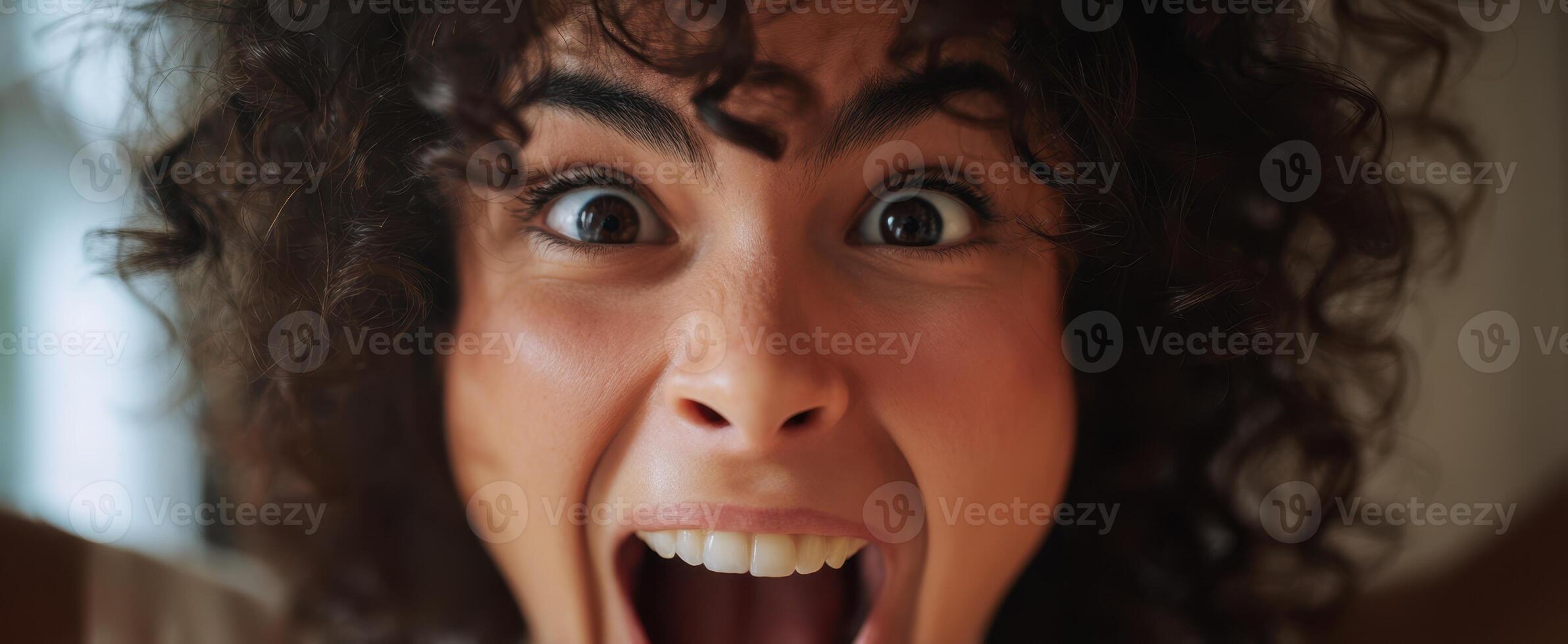 The ecstatic woman expressing sheer joy with an exuberant scream photo