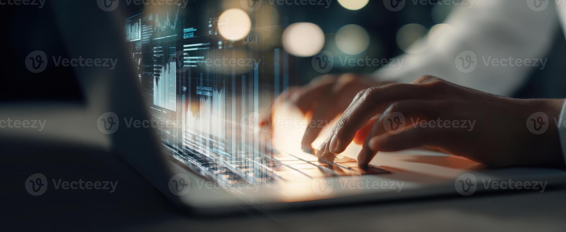 The hands typing on a laptop with digital data overlay at night. photo