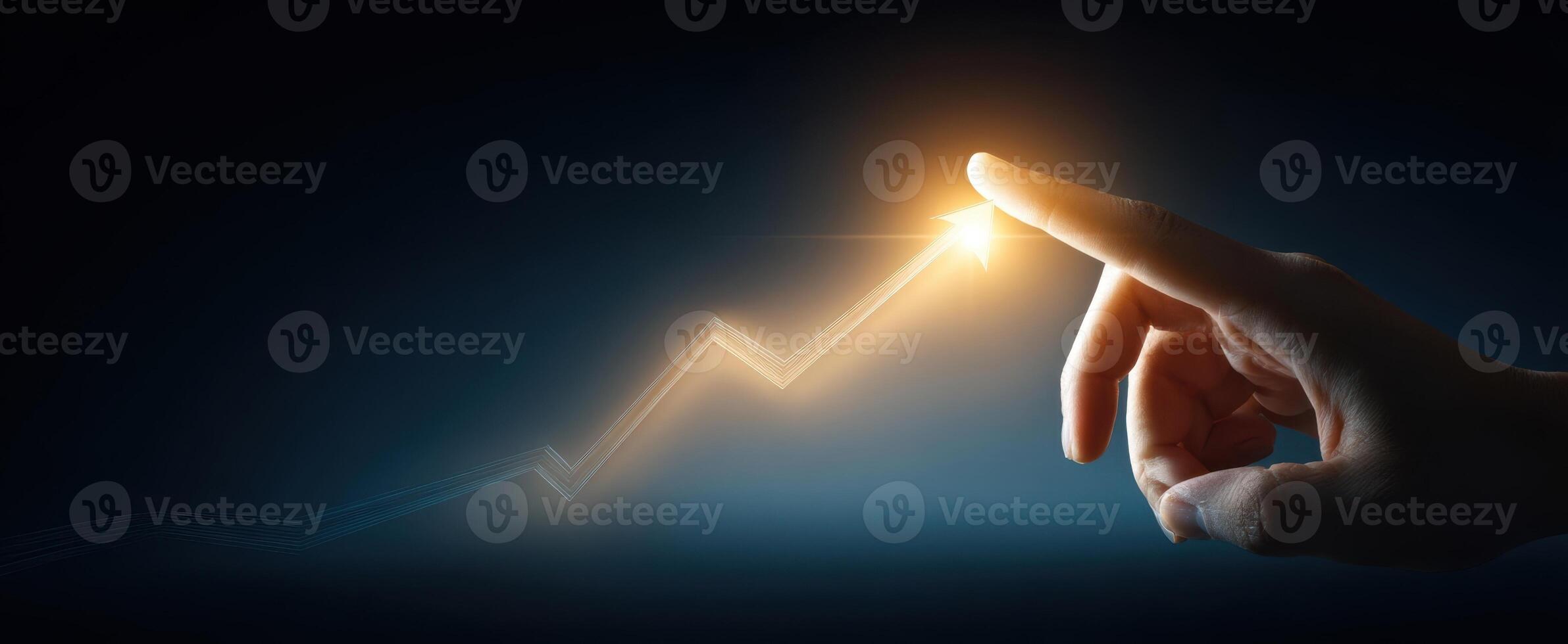 The hand pointing towards a glowing upward trend in a dark backdrop. photo