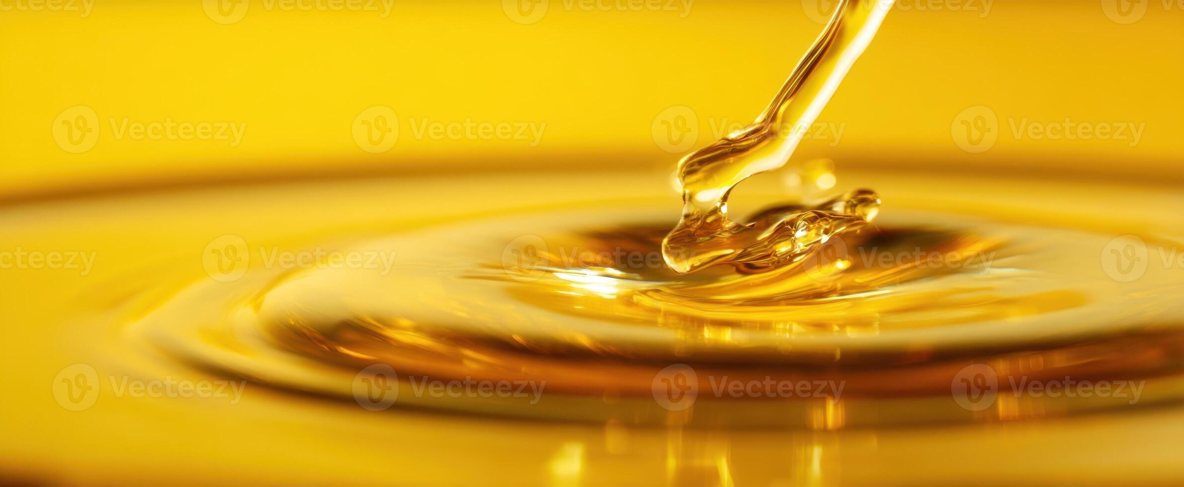 The mesmerizing drop of golden oil creating gentle ripples on the surface. photo