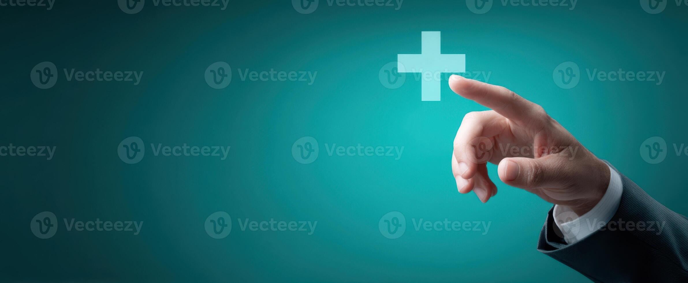 The hand pointing towards a positive cross symbol on a blue background. photo