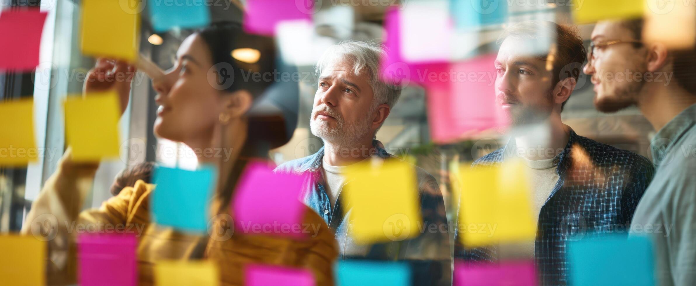 The creative brainstorming session with colorful sticky notes in an office environment. photo