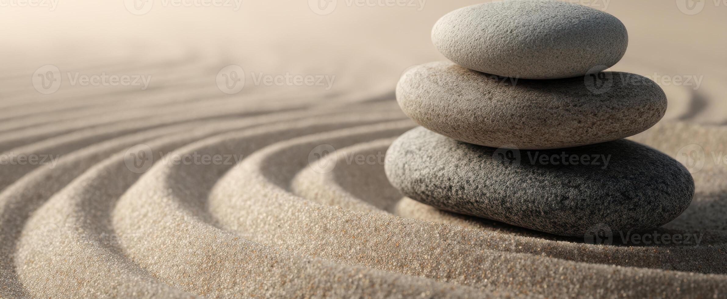 The serene balance of stones resting on smooth, flowing sand. photo