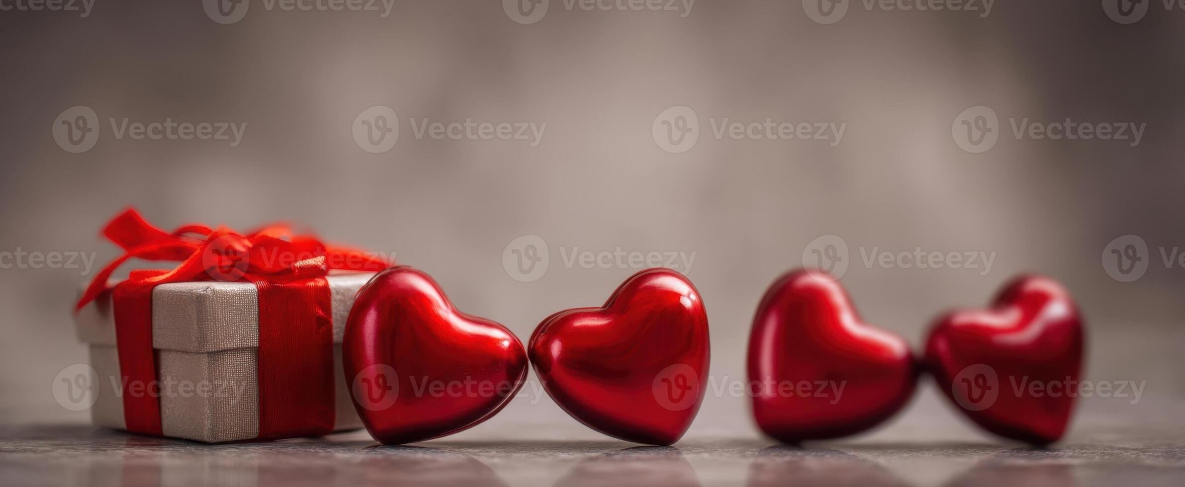 The vibrant red hearts and gift box ideal for romantic celebrations. photo
