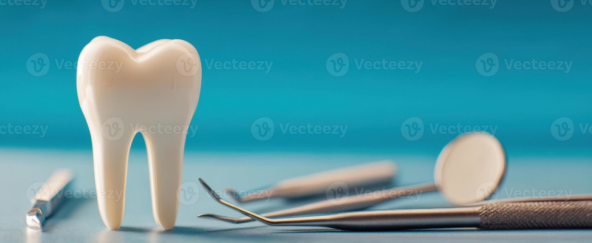 The tooth surrounded by dental instruments on a blue background. photo