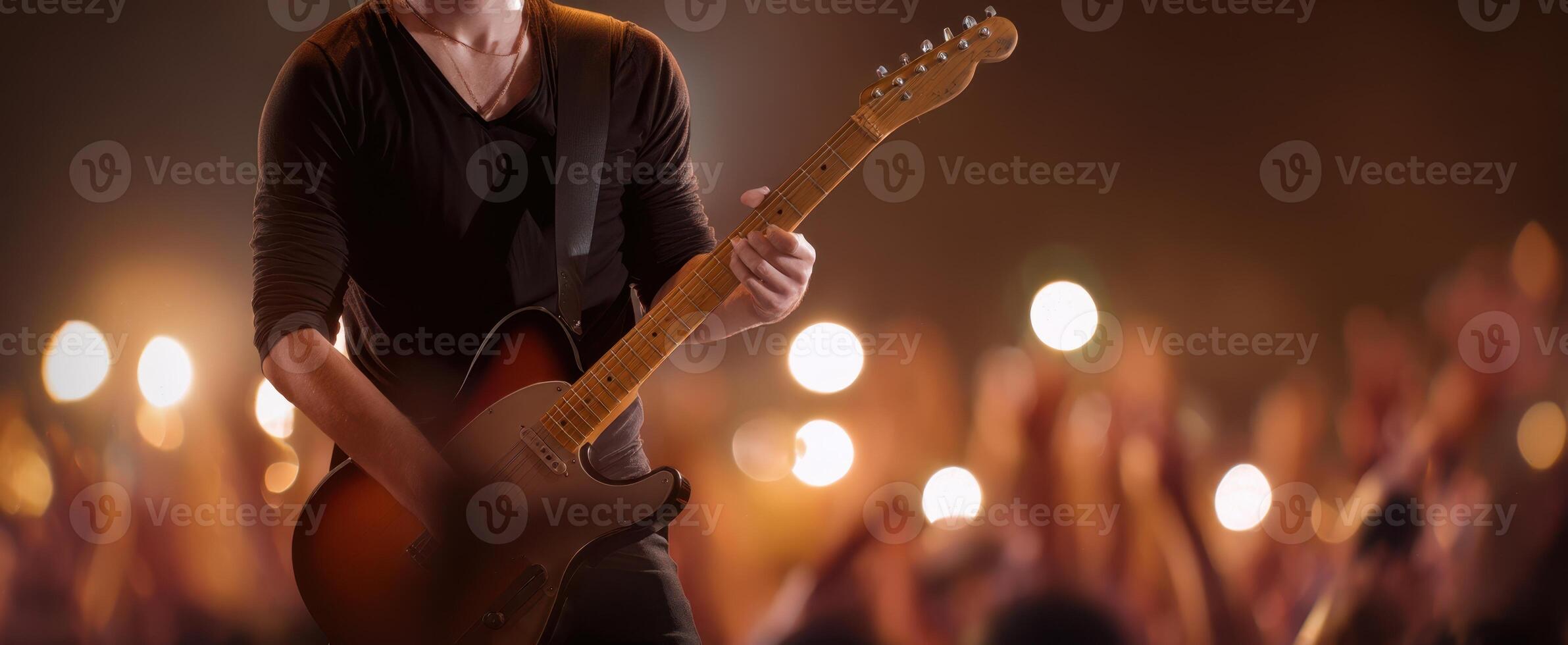 The passionate musician electrifying the crowd with a captivating guitar performance. photo