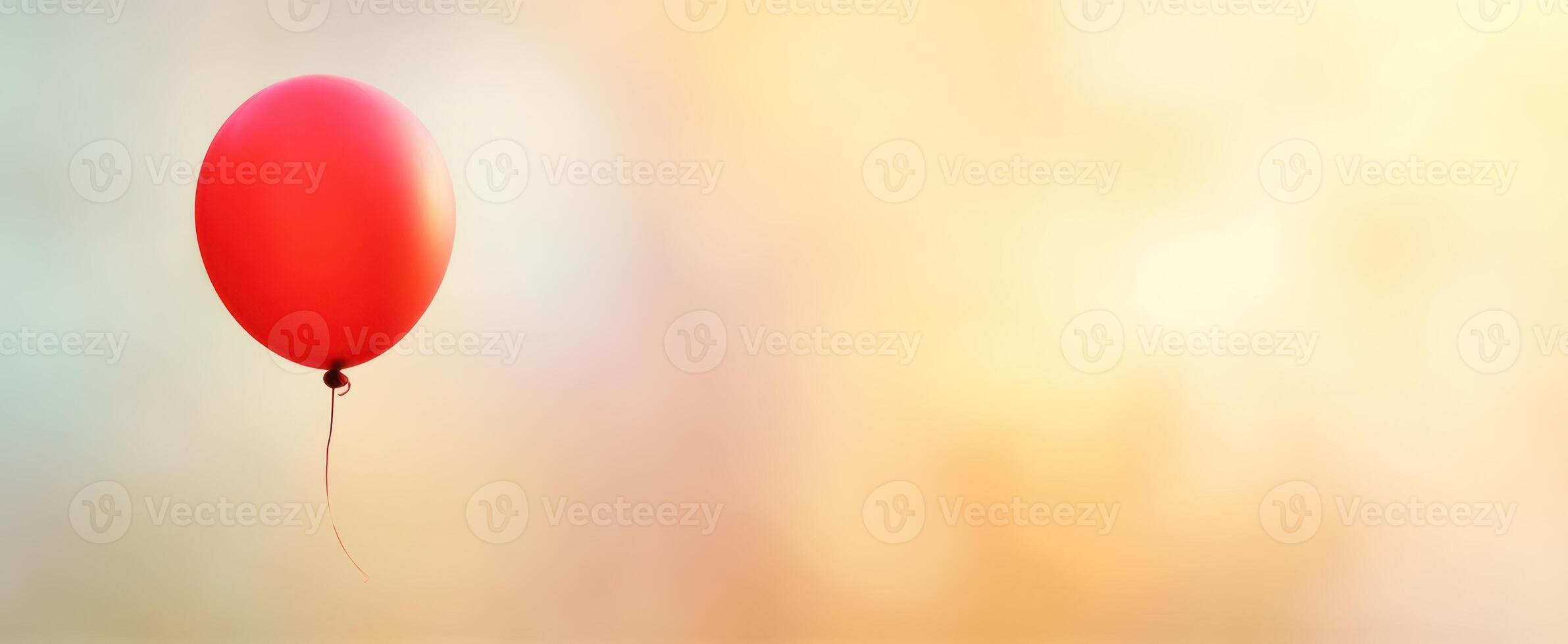 The vibrant red balloon floating beautifully against a soft background. photo