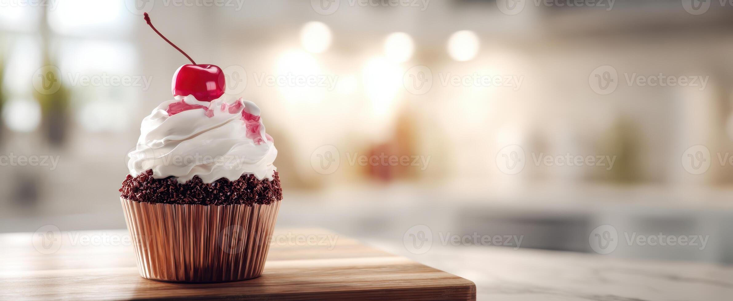 The delicious cupcake topped with whipped cream and a cherry against a cozy kitchen backdrop. photo