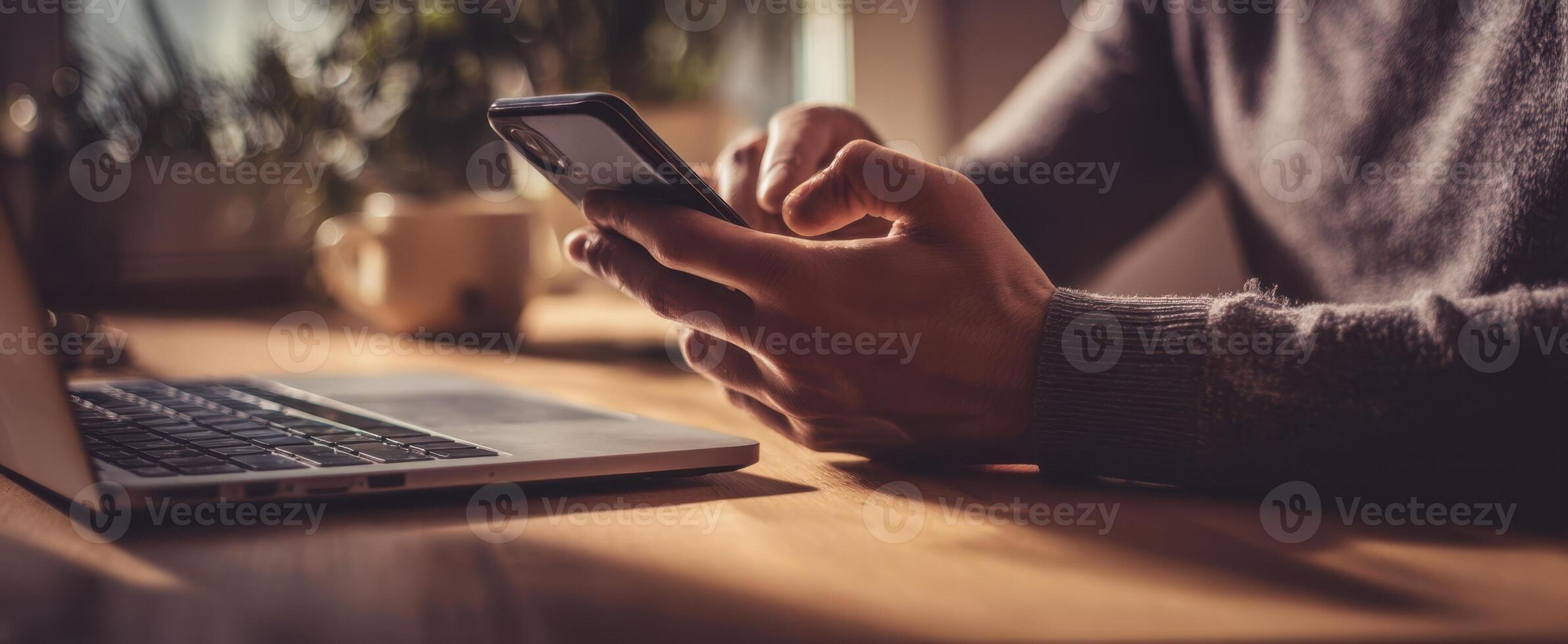 The smartphone being used for multitasking in a cozy workspace setting. photo
