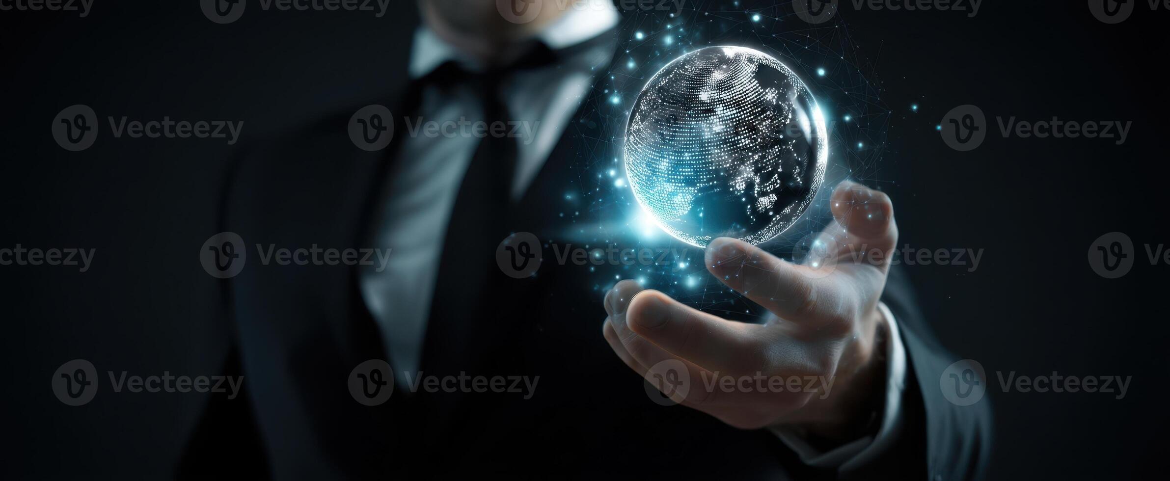 The businessman holding a glowing globe representing innovation and global connection. photo