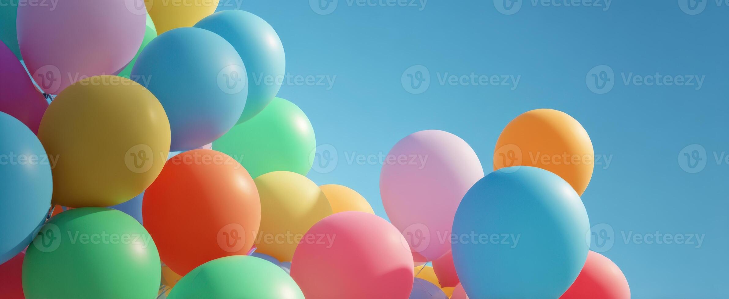 The vibrant display of colorful balloons against a clear blue sky photo