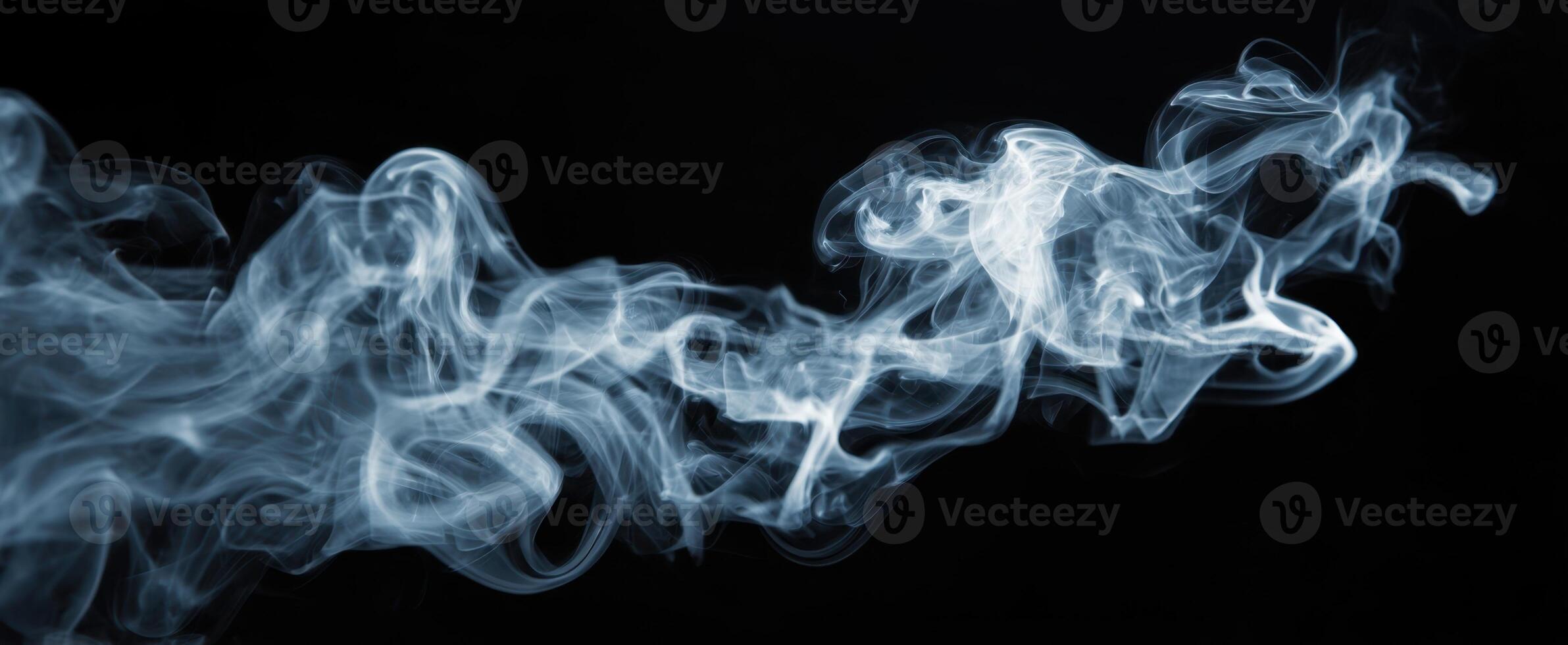 The Ethereal Beauty of Wispy Smoke Against a Black Background photo