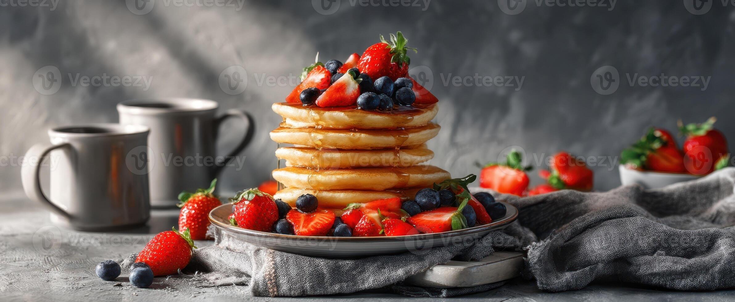 Stack of pancakes with berries and strawberries on a plate photo