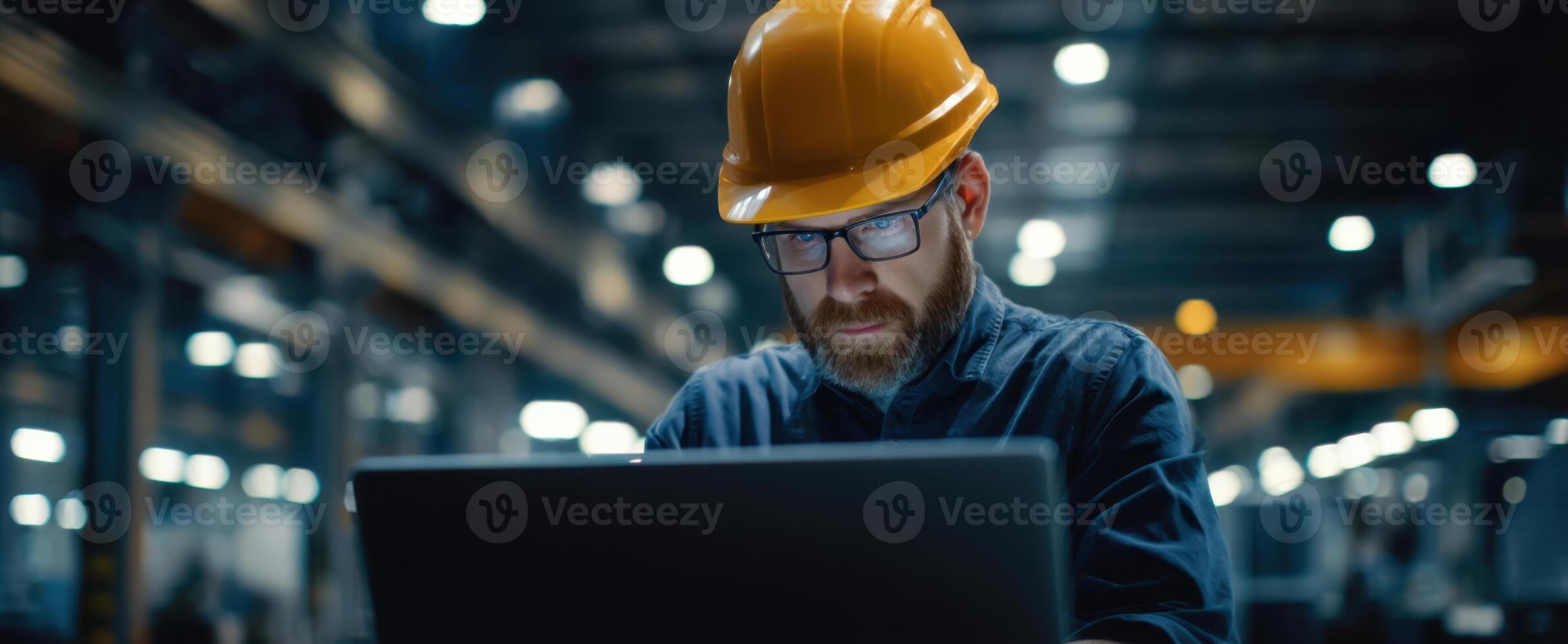 The industrious worker using a laptop in a manufacturing environment. photo