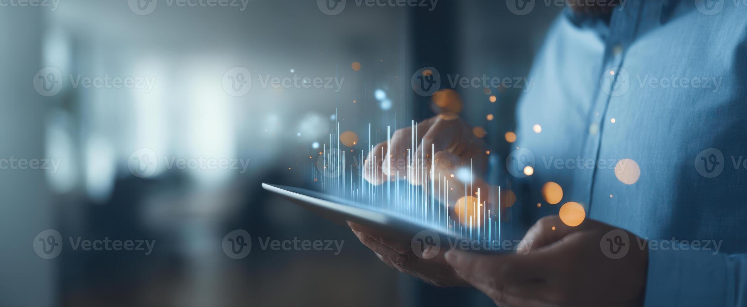 The professional using a tablet to analyze data and visualizations in a modern workspace. photo
