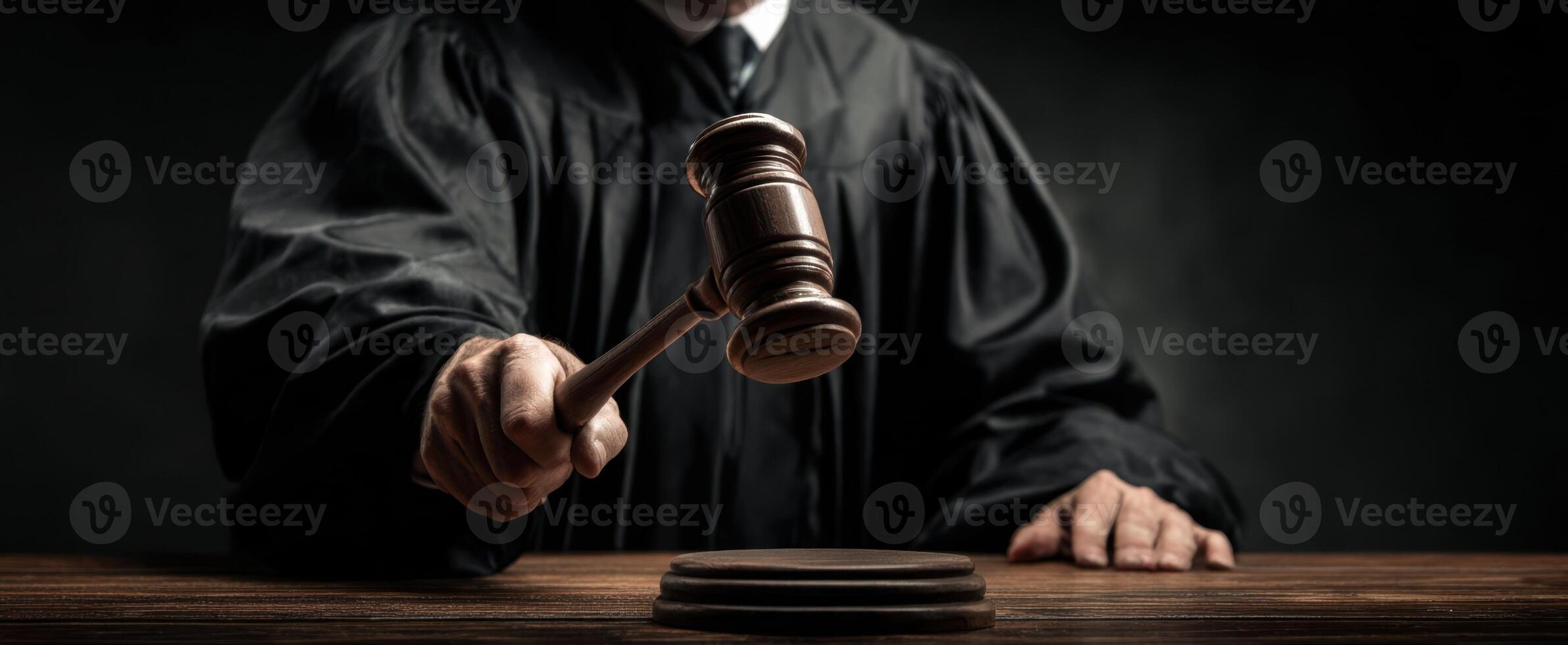 The judge striking the gavel in a solemn courtroom setting. photo