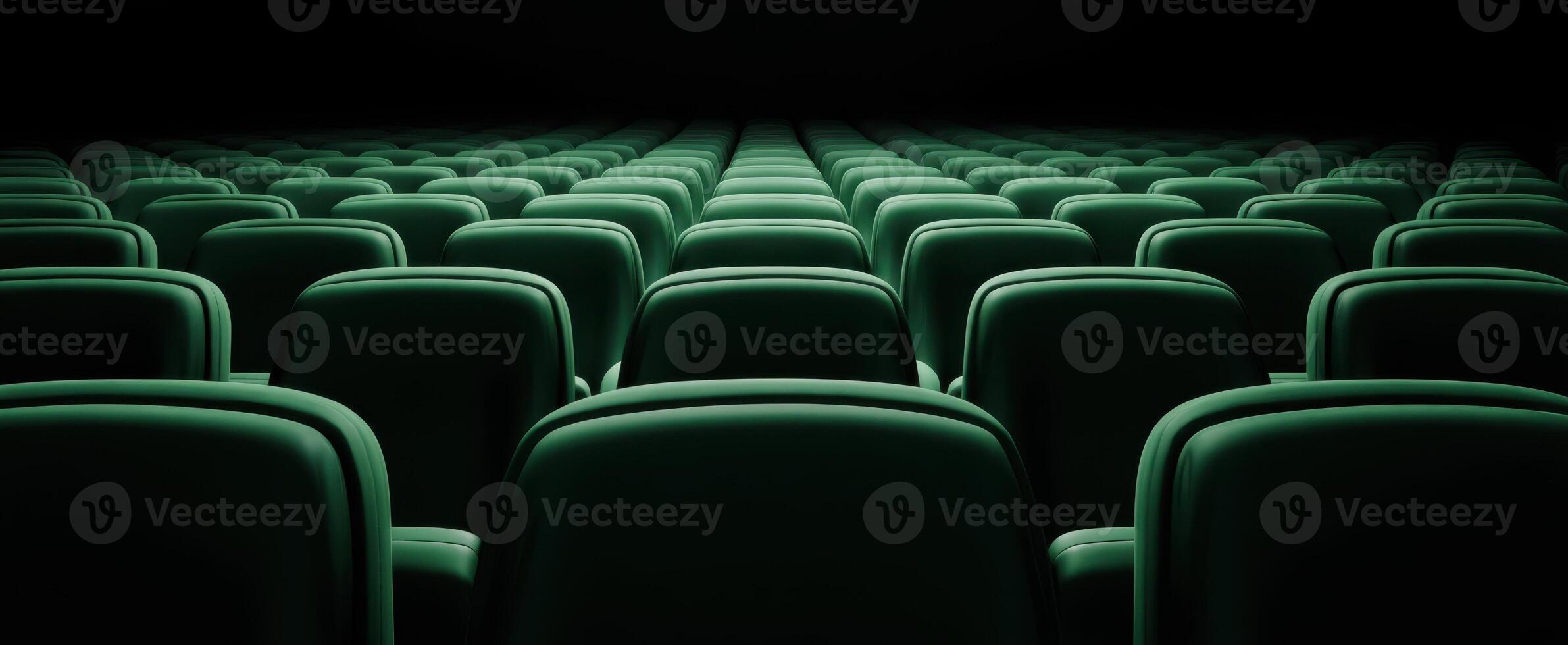 The serene rows of green movie theater seats awaiting audience enjoyment. photo