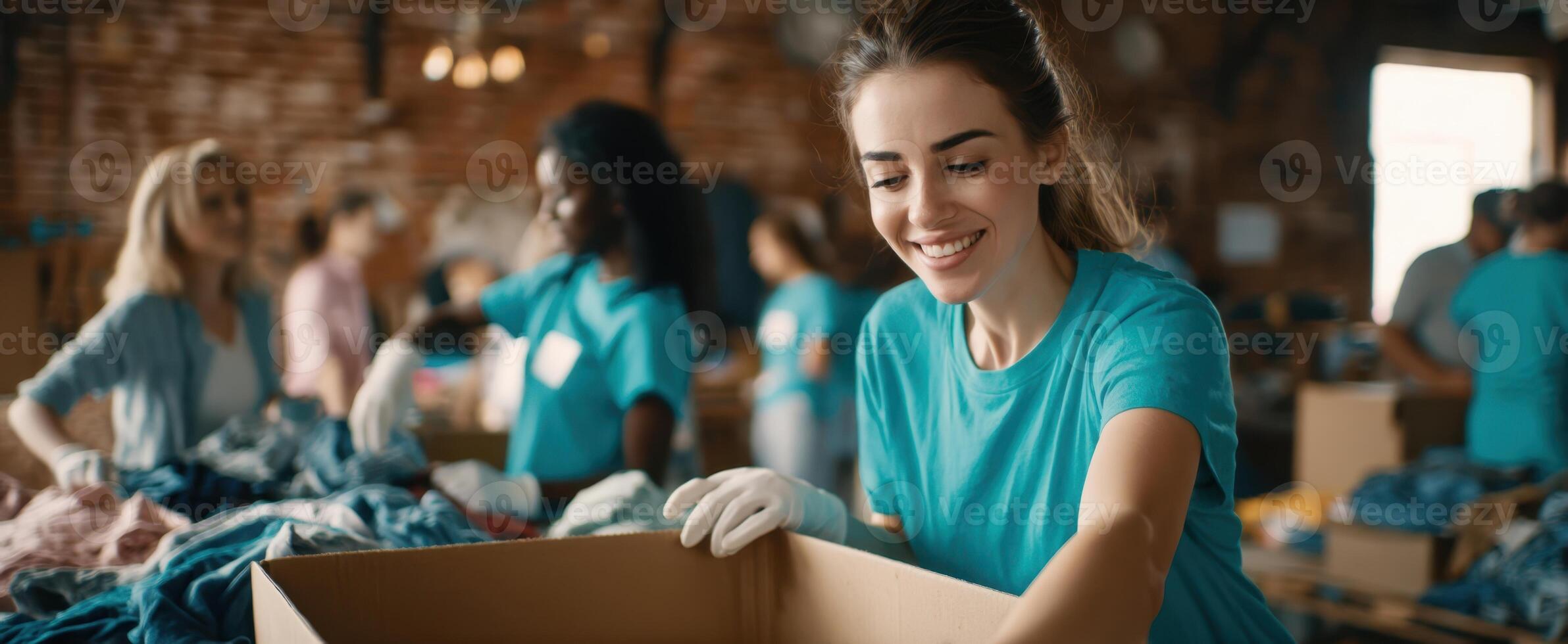 The smiling volunteer sorting clothes in a community donation center. photo