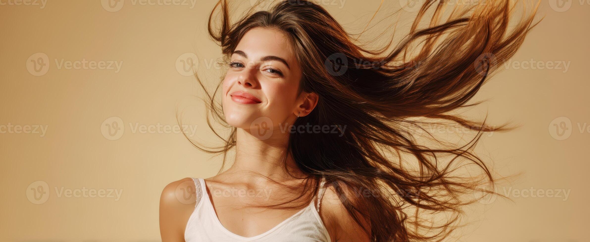 The joyful young woman with flowing hair exuding confidence and happiness. photo