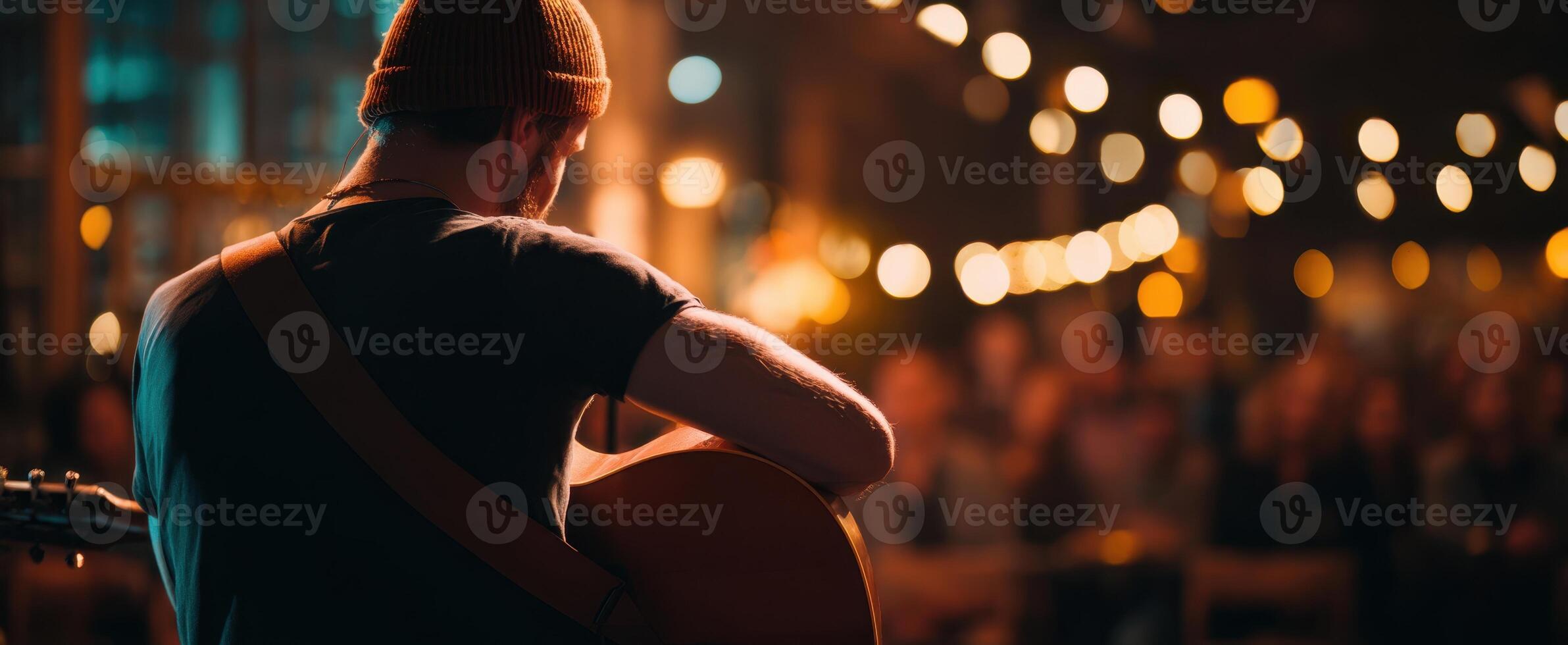 The musician captivating an audience with a soulful guitar performance at night. photo
