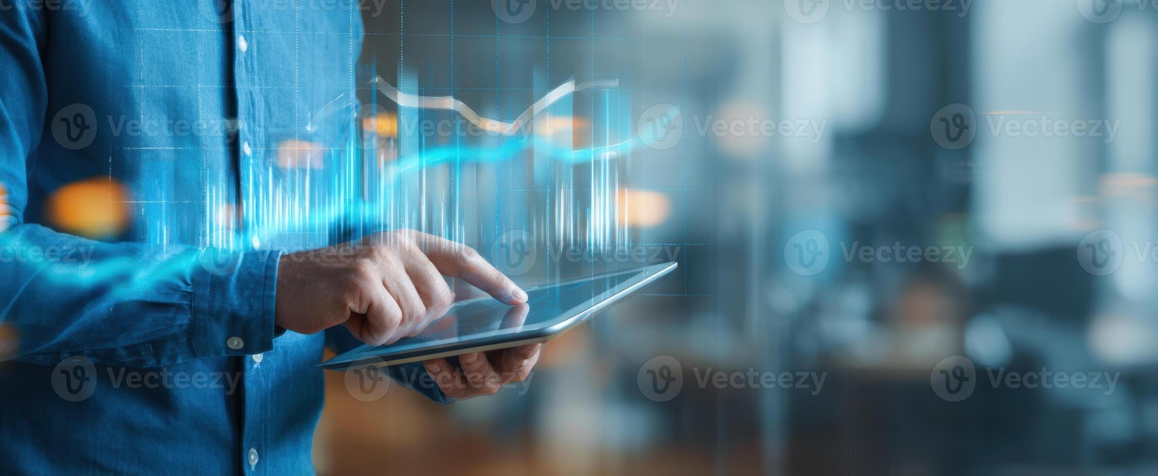 The user interacting with a tablet displaying financial data and analytics. photo