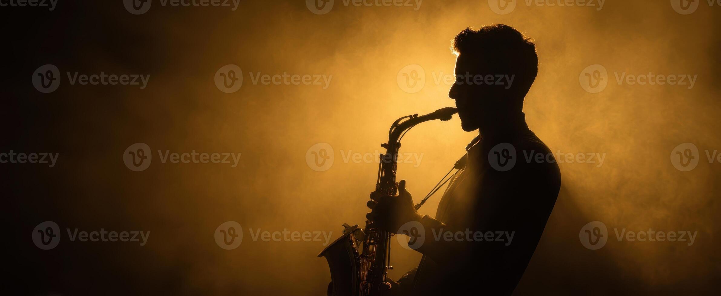 The saxophone player in silhouette against a dramatic smoky backdrop photo