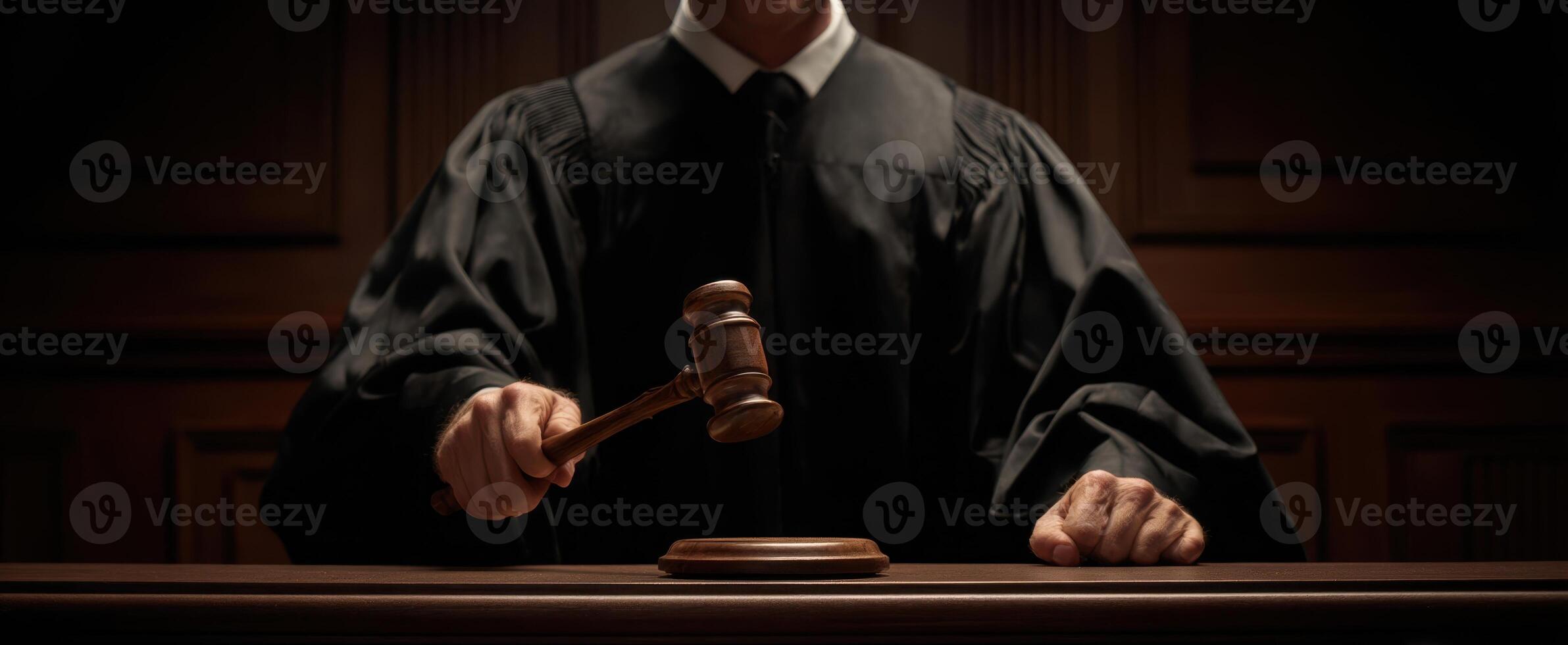 The judge holds a gavel, symbolizing authority and decision-making in the courtroom. photo