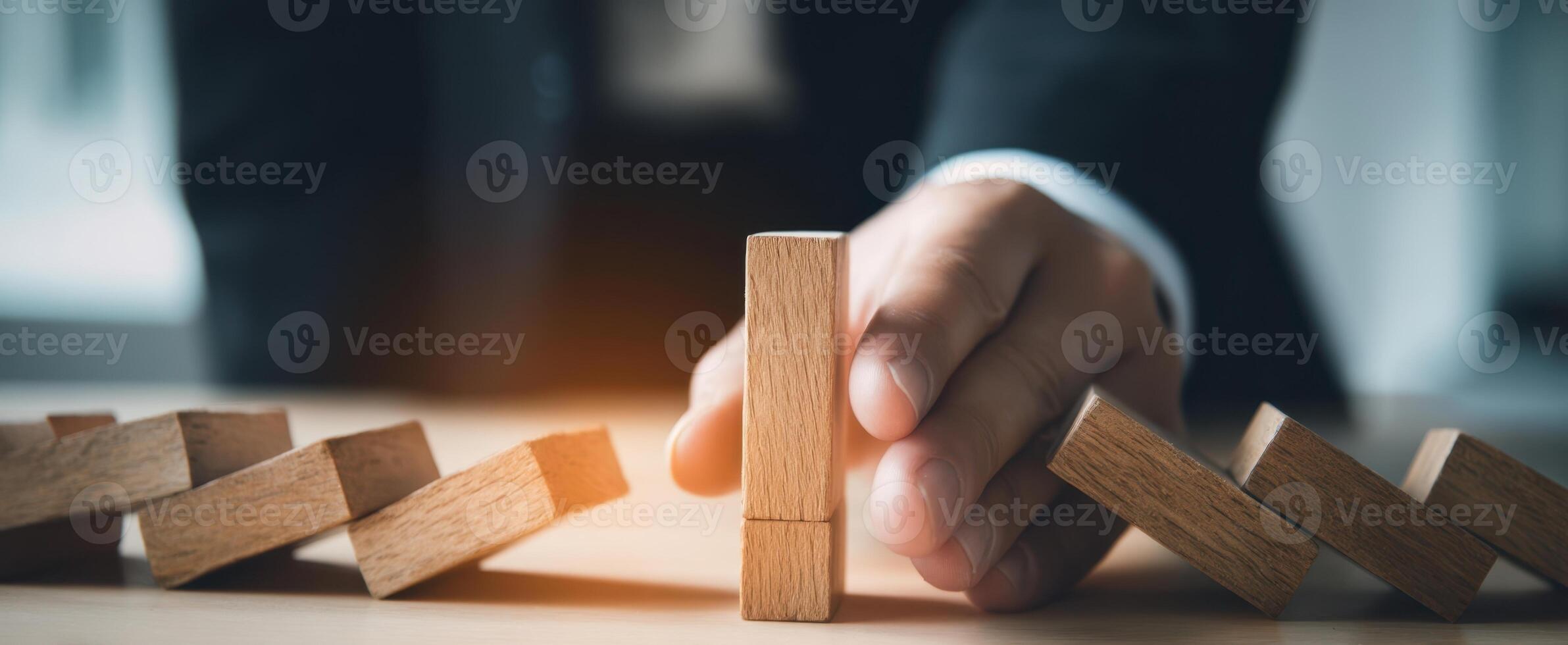 The Hand Stopping Falling Blocks in a Business Strategy Scenario photo