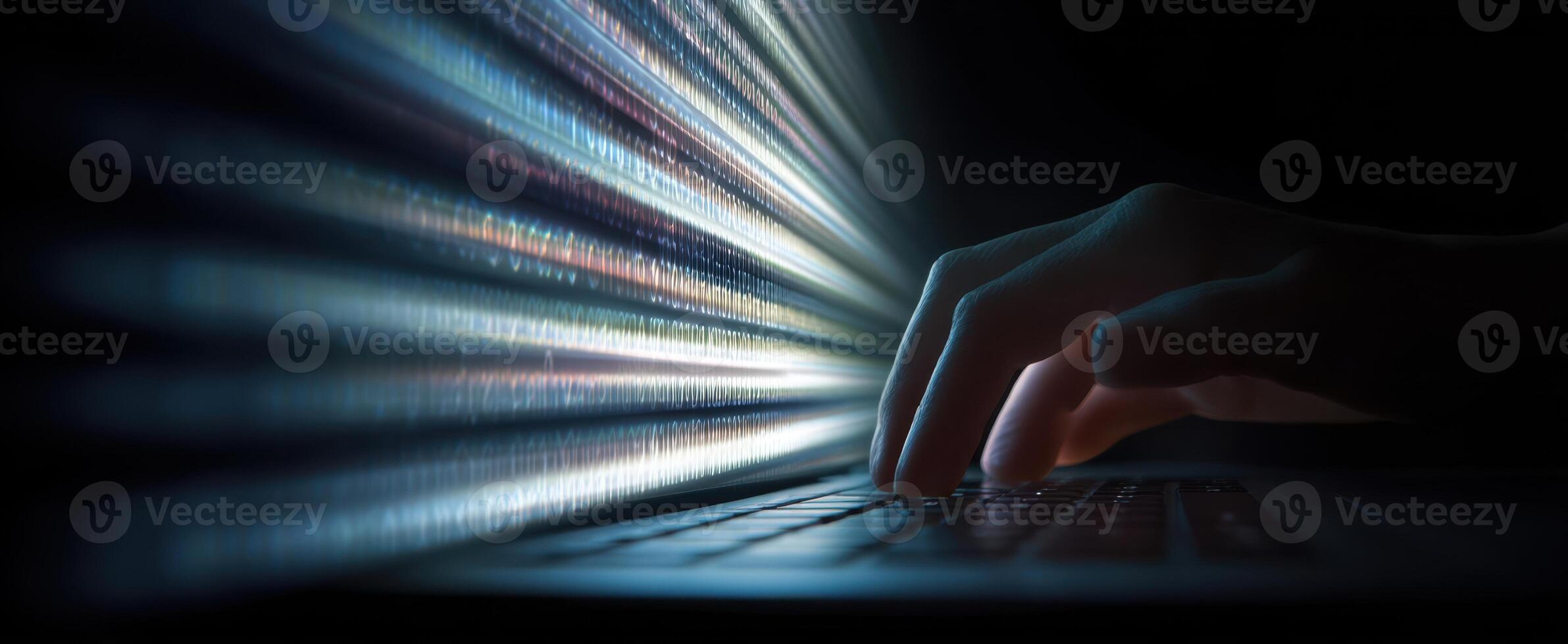 The hand typing on a laptop amidst glowing streams of data and light. photo