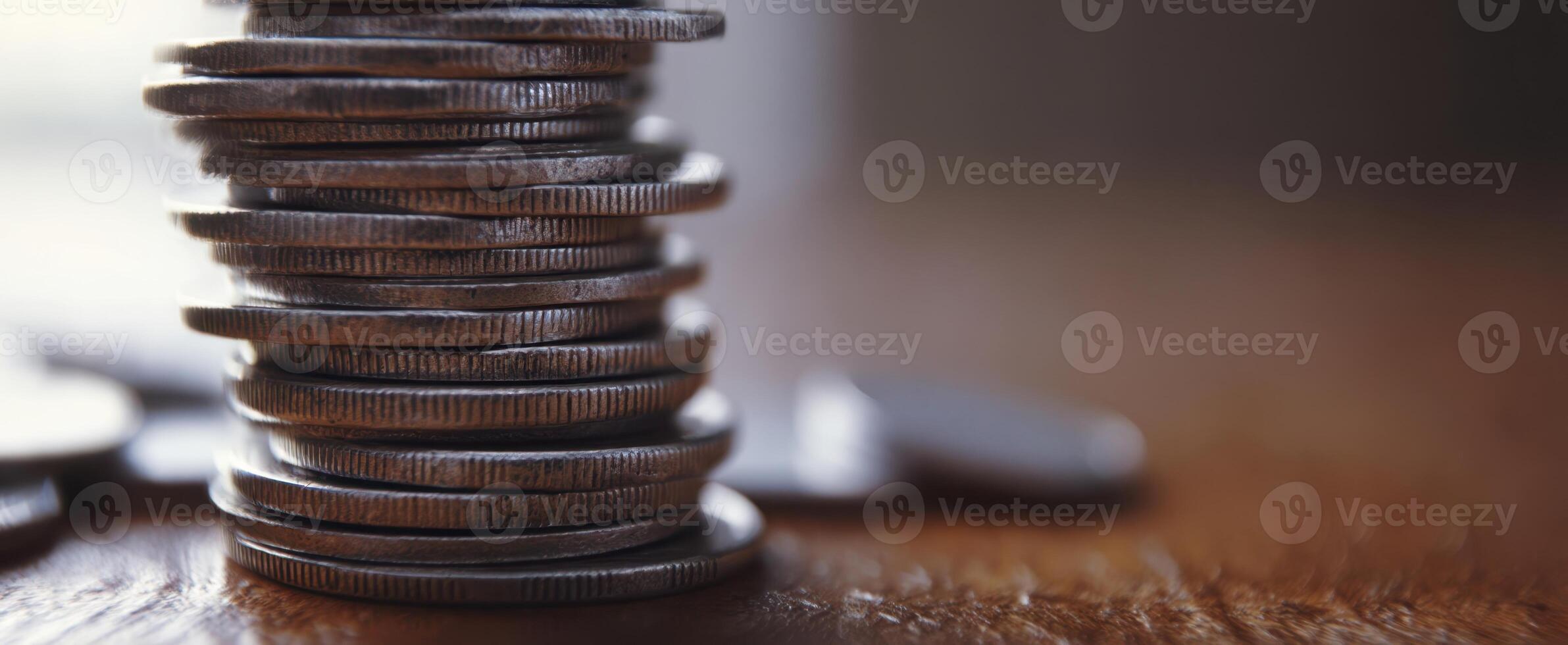 The stacked coins representing wealth and financial prosperity on a wooden surface. photo
