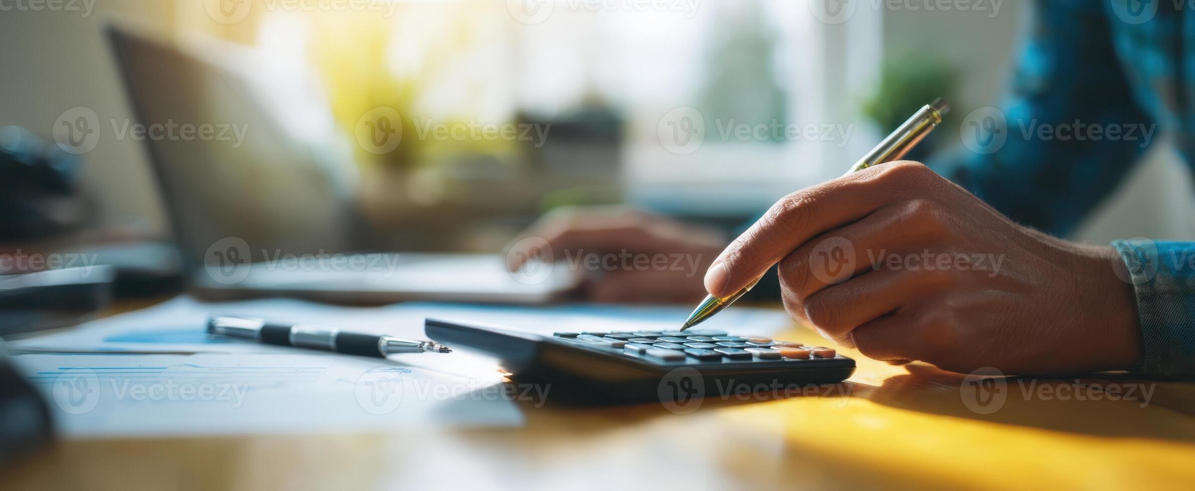 The calculator and pen on a desk for financial planning and analysis photo