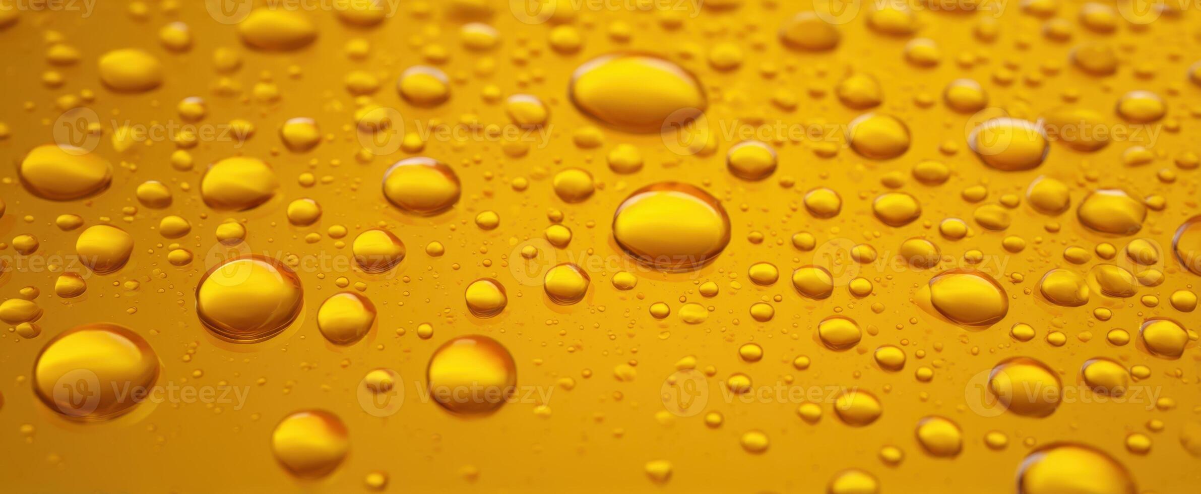 The Close-Up View of Yellow Water Droplets on a Smooth Surface photo