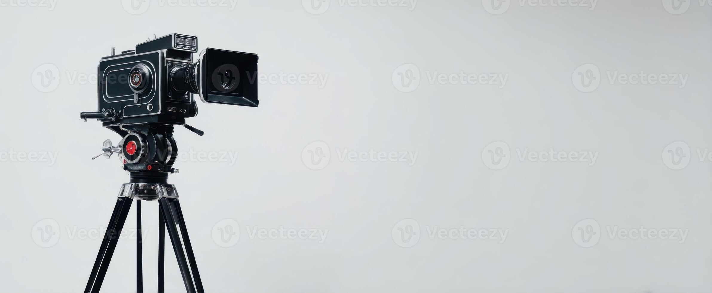 The vintage camera on a tripod against a minimalistic background photo