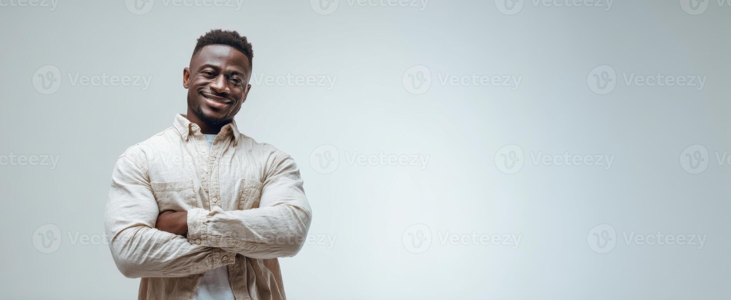 The confident man smiling with crossed arms in a bright studio setting photo