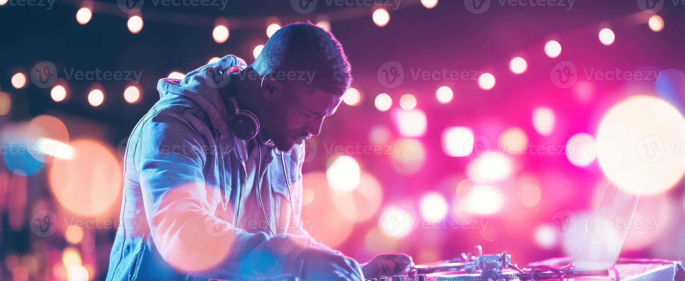 The DJ creating an electrifying atmosphere under vibrant lights at a night party. photo