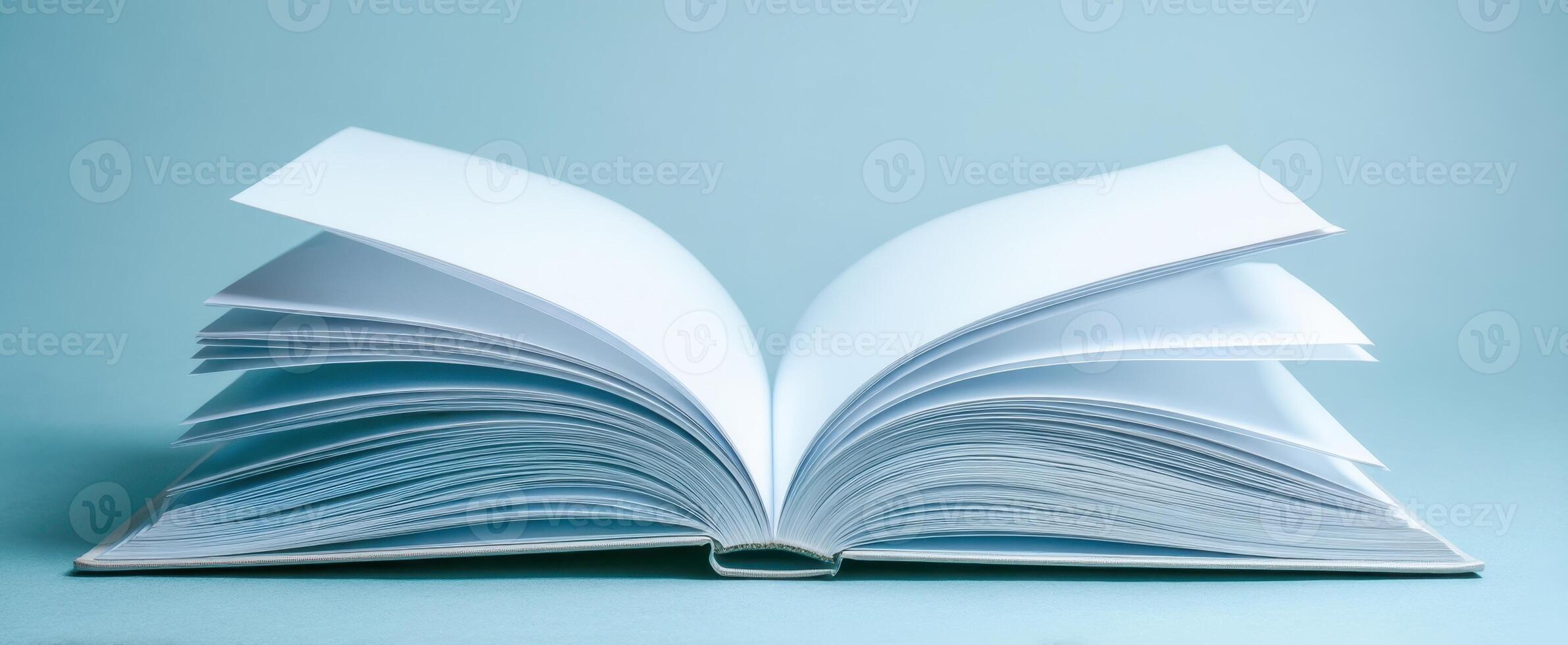 The open book with blank pages on a serene blue background photo