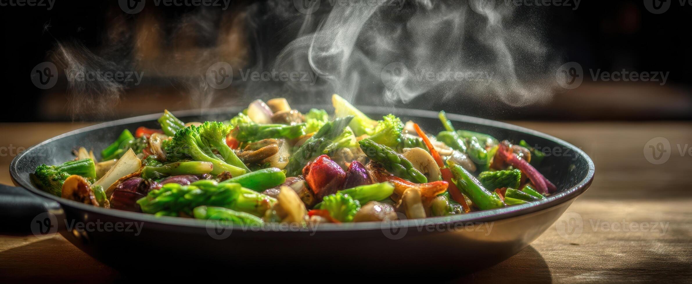 The vibrant stir-fried vegetables steaming in a black pan on a wooden table. photo