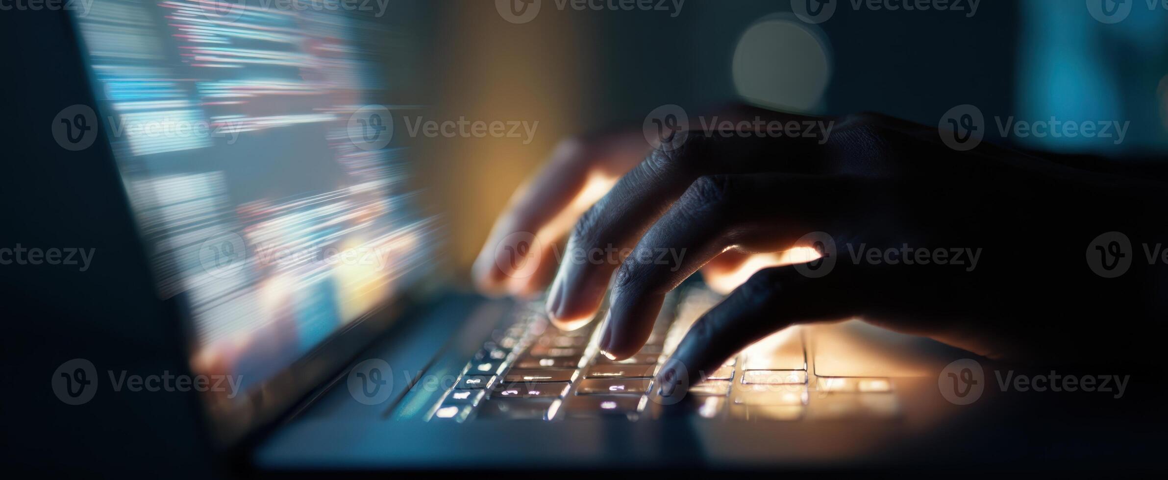 The Hands Typing on a Laptop in a Dimly Lit Environment photo