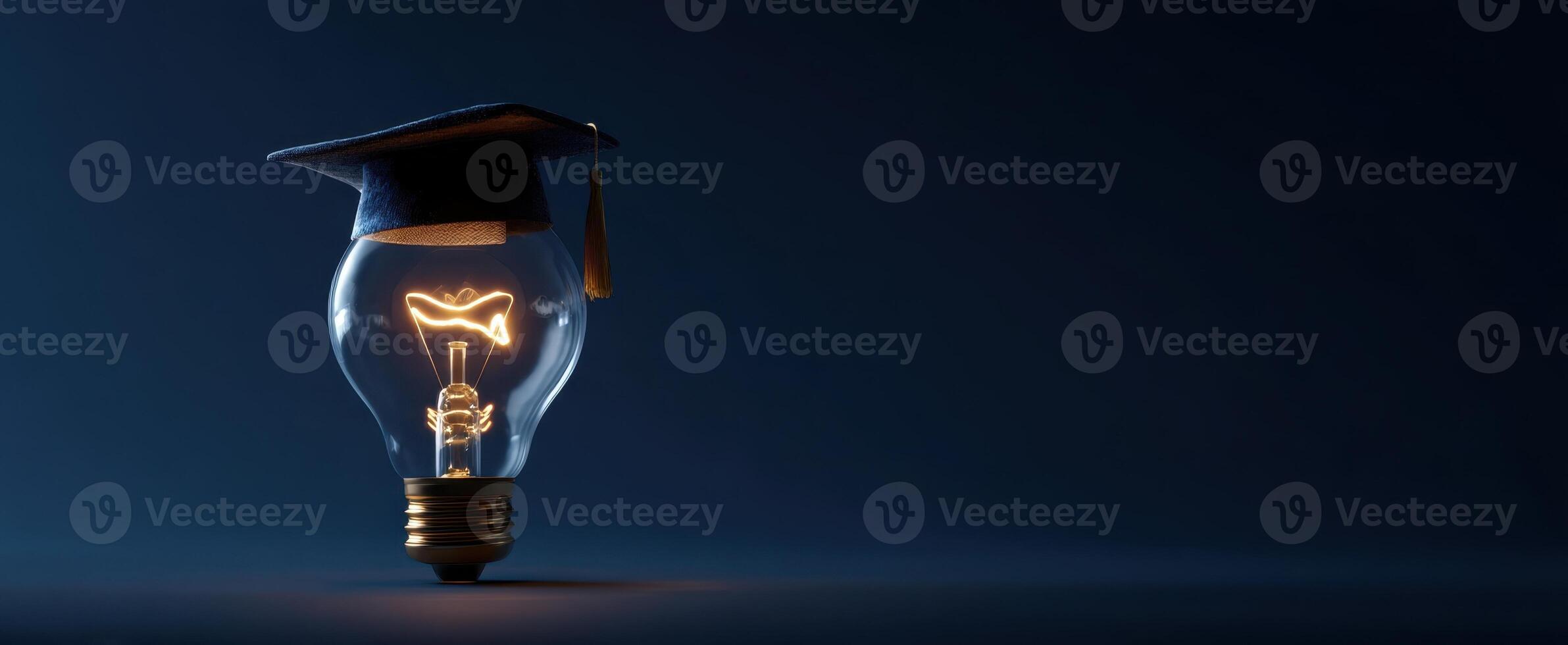 The graduation cap nestled on an illuminated lightbulb symbolizing knowledge and inspiration. photo