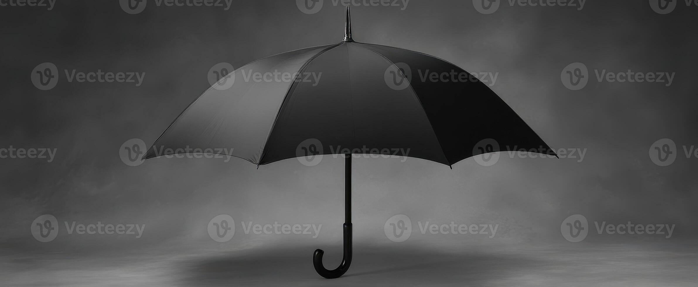 The elegant black umbrella against a textured dark background in a minimalist style. photo